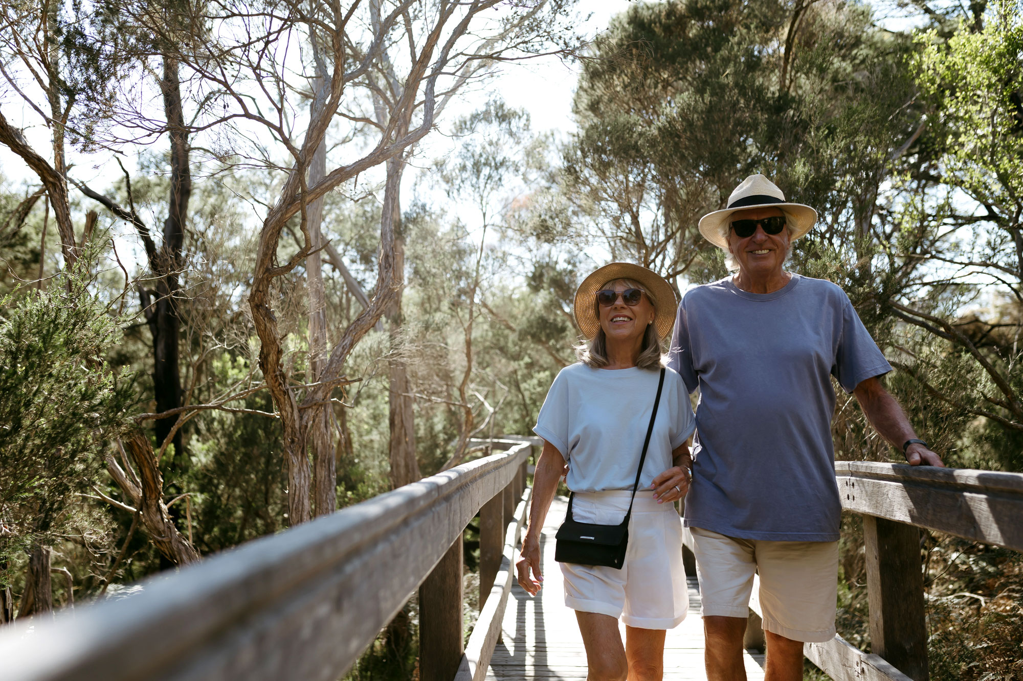 A couple in their 70's seen walking over a footbridge in the bush